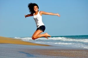 How can I improve my chances of falling pregnant? A healthy woman jumping on the sand